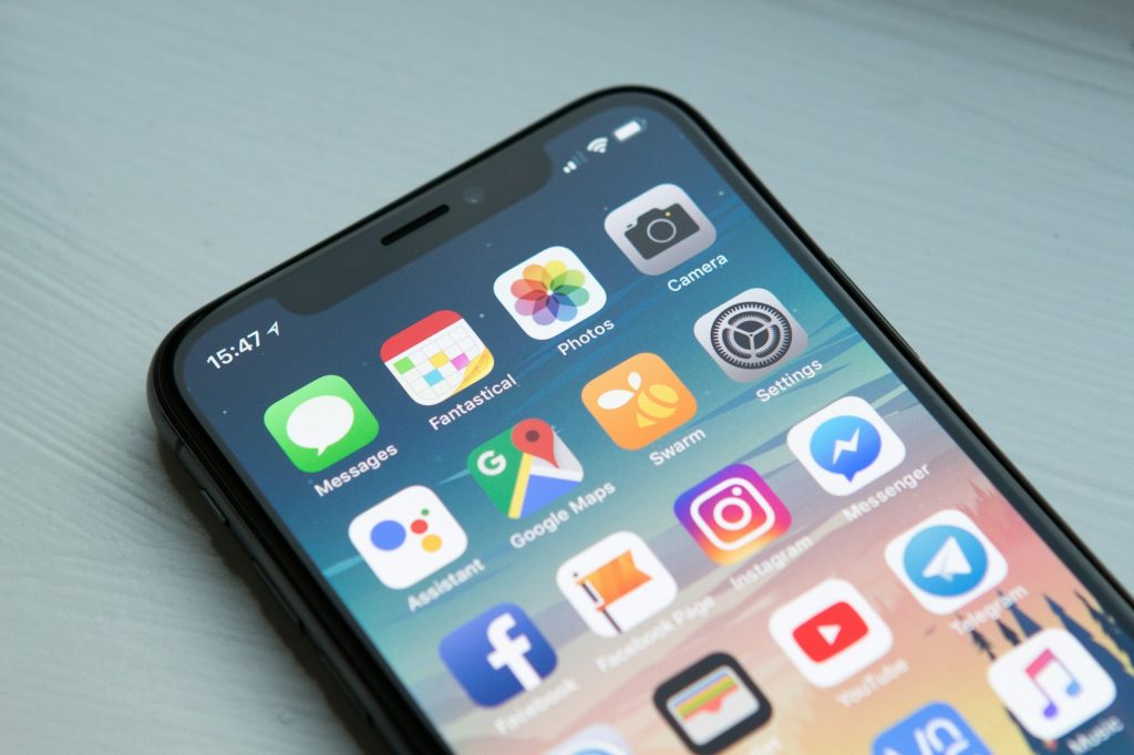 Close view of a smartphone home screen on a pale desk